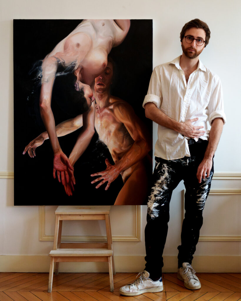 Beautiful young artist posing alongside his masterful and romantic oil painting